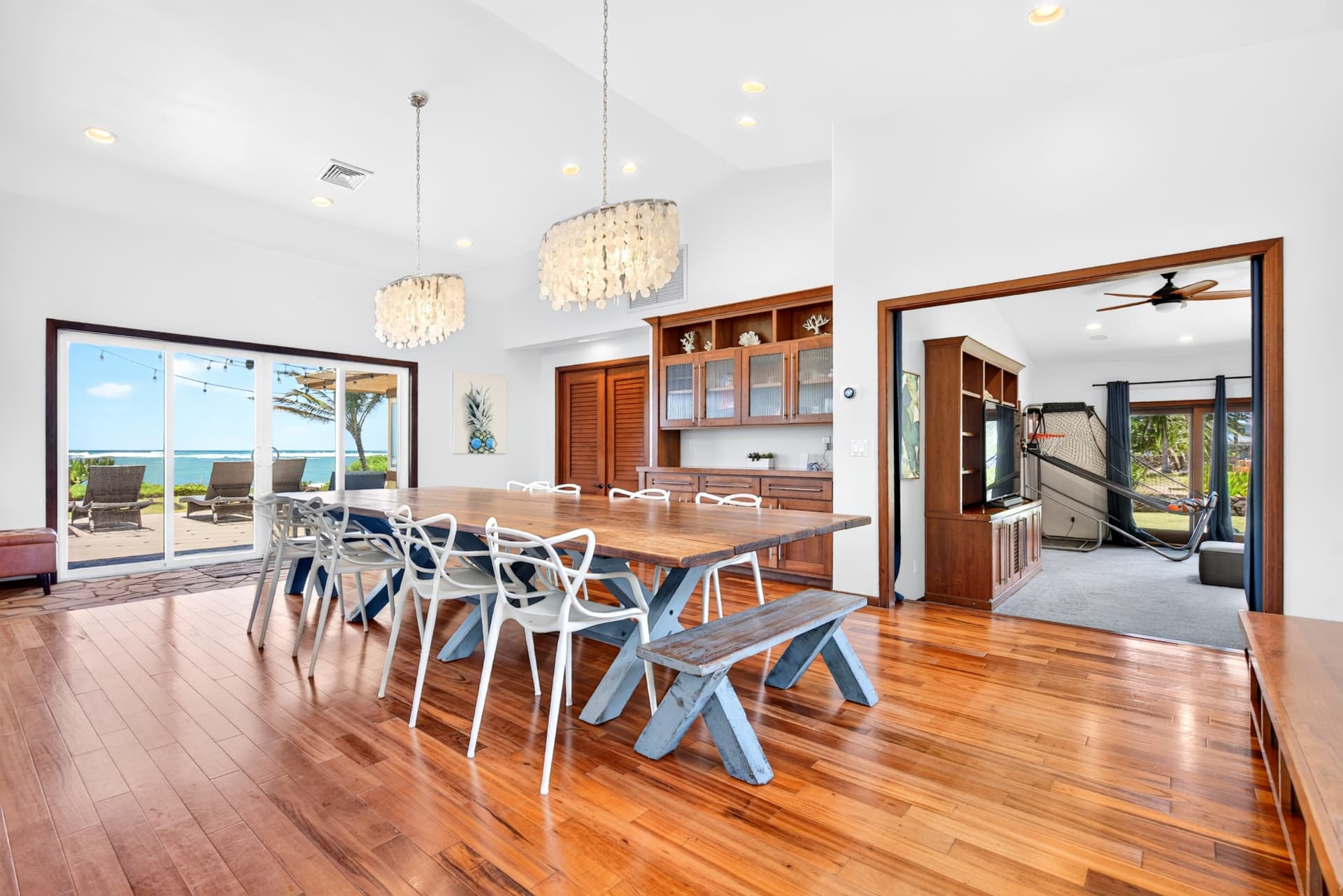 Luxury Oahu dining room with ocean views and warm wood floors