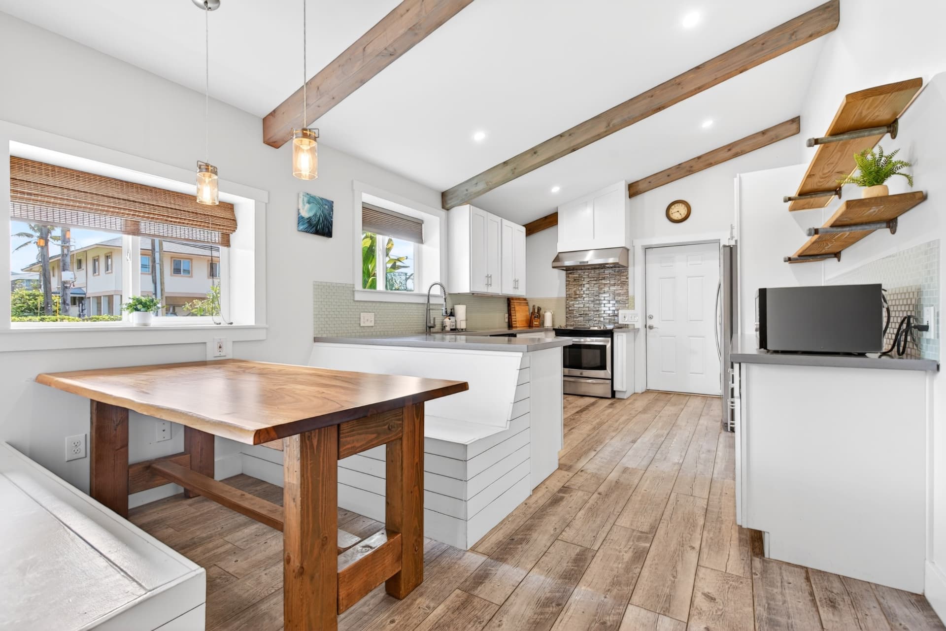 Bright Oahu kitchen and dining space with exposed wood beams