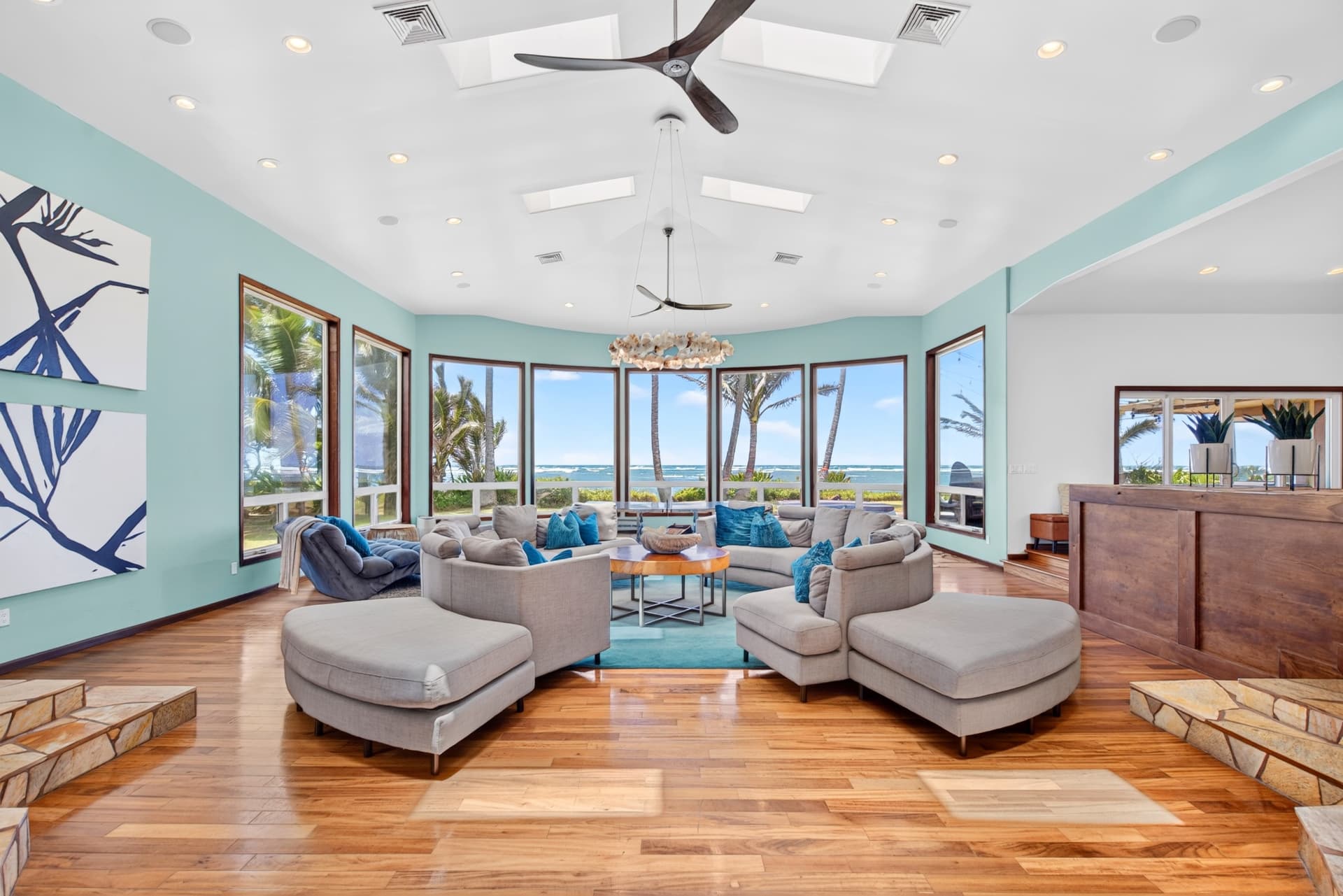 Bright Oahu living room with panoramic ocean views and tropical interiors