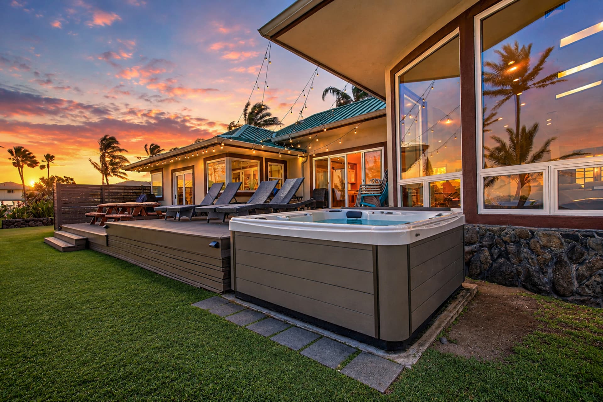 Virtual twilight image of an Oahu home with hot tub and glowing sunset sky