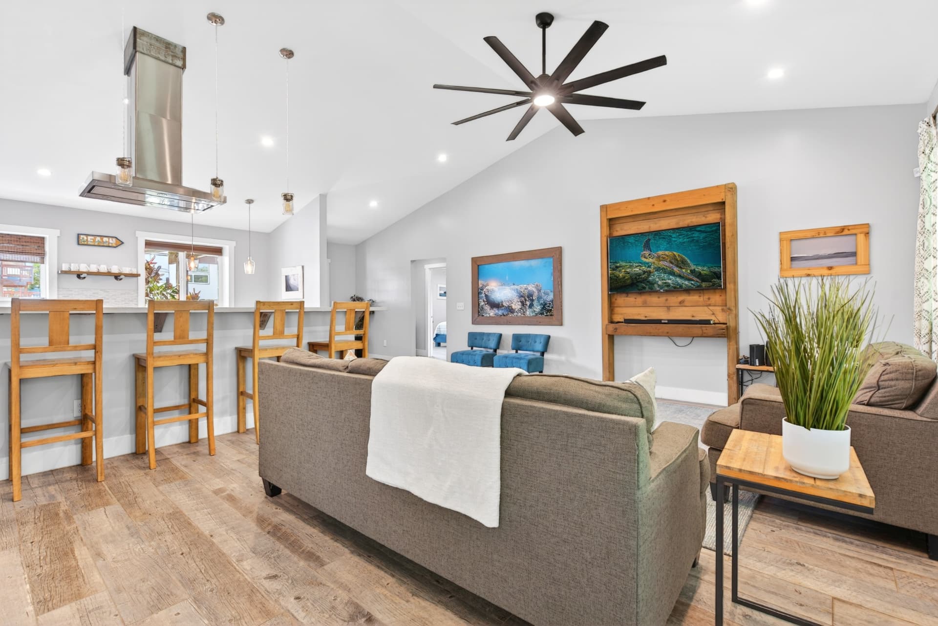 Bright open-plan Oahu living room with vaulted ceiling and island-inspired decor