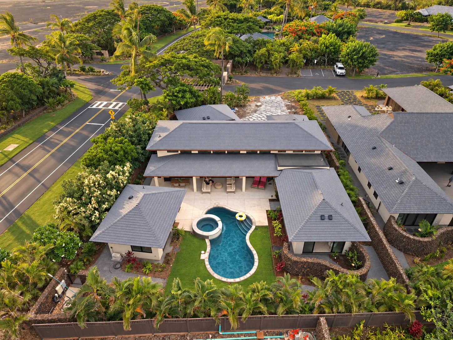 Aerial view of a tropical Oahu estate with a swimming pool and lush landscaping