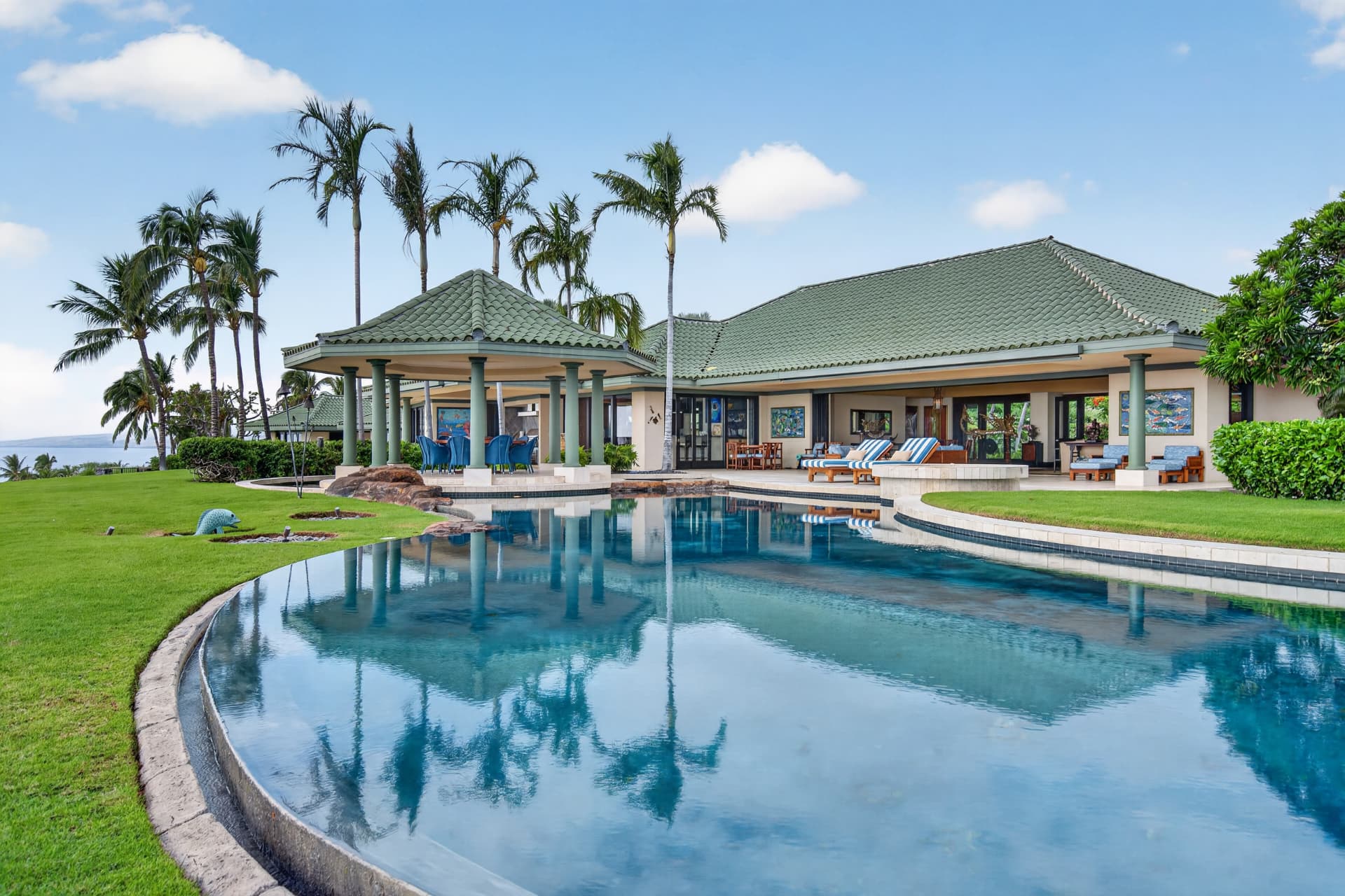 Oceanfront Oahu estate with a large swimming pool and tropical landscaping