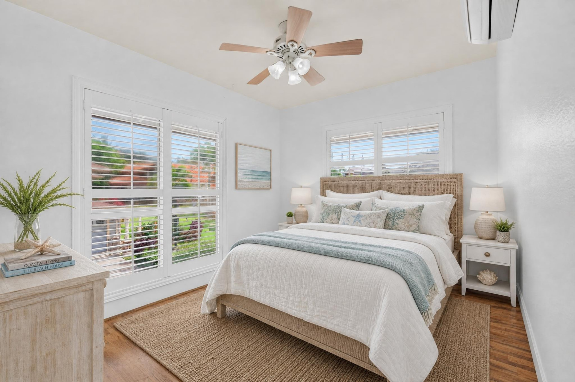 Virtually staged coastal bedroom with light wood furnishings